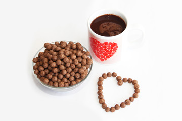 corn brown balls in a glass plate and a heart-shaped pattern for valentines day