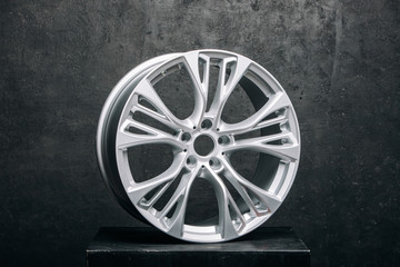 Сar metal rims at the grey background