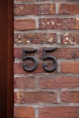 number 55 on brick wall
