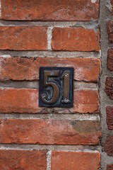 number 51 on brick wall