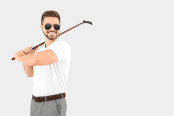 Handsome male golfer on white background