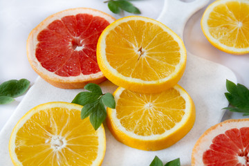 Close up on fresh fruits: oranges and grapefruits. Juicy sliced oranges. Healthy vegan food