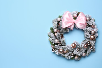 Beautiful Christmas wreath on color background