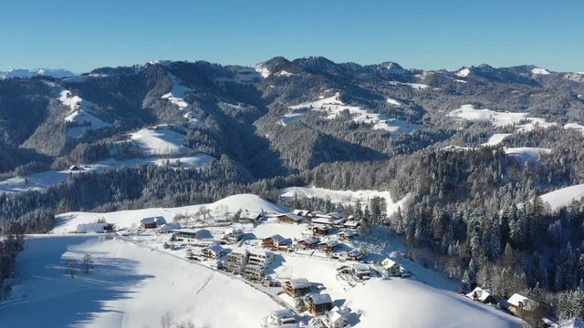 Aerial view of the village Menzberg in winter wtih Mount Napf in the background in Switzerland