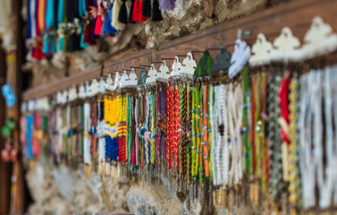 Stand of a street vendor selling anklets and bracelets.