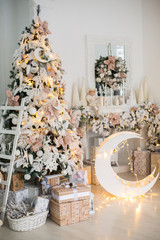 Close up a Christmas tree lights glittering at night. New Year fir tree with decorations and illumination. Xmas tree decorations background. Many large golden balls on fir tree New Year and Christmas