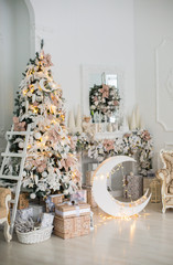 Close up a Christmas tree lights glittering at night. New Year fir tree with decorations and illumination. Xmas tree decorations background. Many large golden balls on fir tree New Year and Christmas