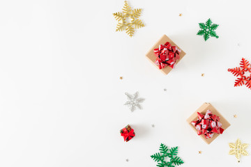 Top view of Christmas decorations and gift boxes on white background.