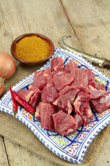 raw lamb meat on a wooden table