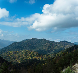 Naklejka premium View of mountains. View of the mountains on the road to Yedigoller. Clouds and mountain hills reflect the colors of autumn.