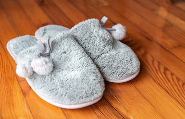 Fototapeta na wymiar Cozy home slippers on wooden floor.