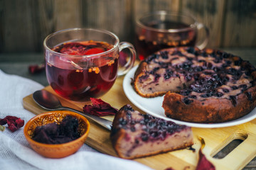 Red tea for two - two cups. Sliced ​​blueberry homemade pie.