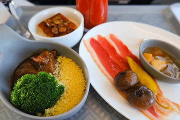 photo of Food served on board of business class airplane on the table