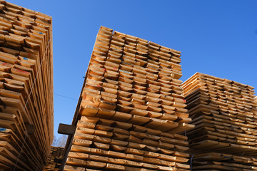 Wood timber in the sawmill. Piles of wooden boards in the sawmill. 
