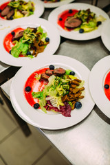 Cooking a delicious main course in the restaurant kitchen. Catering on holiday.