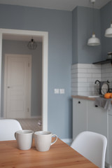 Interior of modern sunny kitchen in a Scandinavian-style apartment. Kitchen furniture, dishes, spices