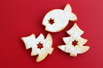 Homemade linzer cookies filled with red jam and dusted with powdered sugar