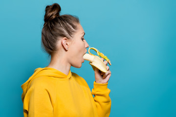 pretty girl putting a banana in her mouth