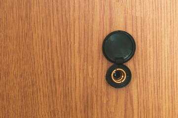 Fototapeta premium front door peephole, wooden background