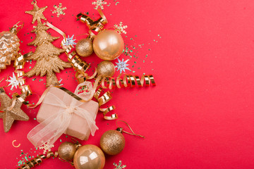 Beautiful festive red background with sparkles and Christmas golden toys. Holiday Content.