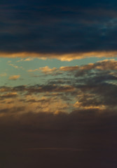 Fototapeta premium Fantastic clouds at sunrise, vertical panorama