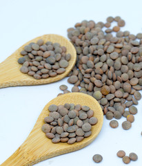 Lentils with white background and wooden spoon
