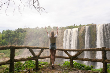 The girl near big waterfall