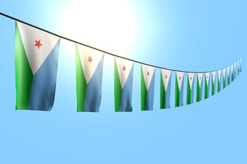 nice many Djibouti flags or banners hanging diagonal on string on blue sky background with selective focus - any celebration flag 3d illustration..