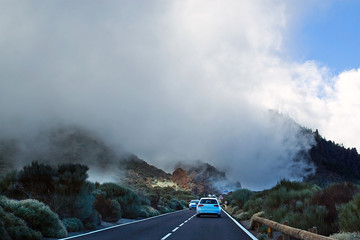 fog descends towards the road between the gorges on the track to the Teide volcano, between the...