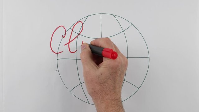 The lecturer writes on a whiteboard the term "climate emergency" at a lecture on the climate change. Using of a visual aids
