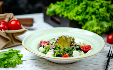 greek salad topped with pickles