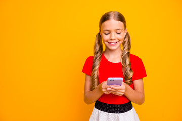 Photo of nice small lady holding telephone hands young influencer writing new post for own popular blog wear casual red white dress isolated bright yellow color background