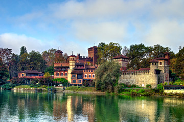 Fototapeta na wymiar Medieval fortress in Valentino Park, Turin, Piedmont. The buildings, built as a pavilion of the Italian General Exhibition in Turin in 1884, represent castles from the 15th century. Autumn view.