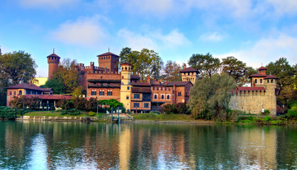 Fototapeta na wymiar Medieval fortress in Valentino Park, Turin, Piedmont. The buildings, built as a pavilion of the Italian General Exhibition in Turin in 1884, represent castles from the 15th century. Autumn view.