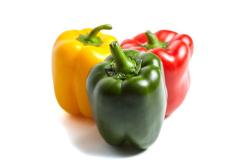 Red, green, and yellow bell peppers isolated on white background. Three sweet peppers in different colors, vegetable ingredient, healthy food