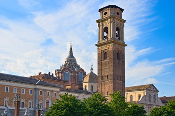 Fototapeta na wymiar Turin Cathedral with Guarini Dome, bell tower and Roman walls remains seen at sunset from the Palatine Gate park