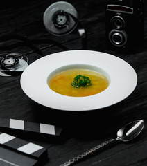 vegetable soup with herbs and spoon