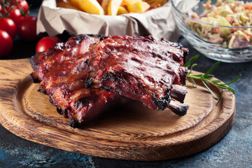 Spicy barbecued pork ribs served with BBQ sauce