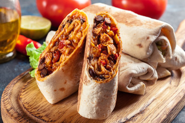 Burritos wraps with mincemeat, beans and vegetables - obrazy, fototapety, plakaty