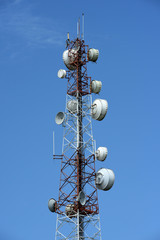Wireless Communication Antenna With bright sky.Telecommunication tower with antennas.High pole for signal transmission. There are both wireless phone systems and microwave systems.