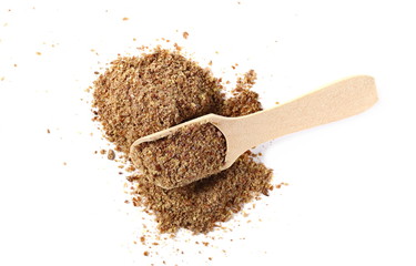 Ground, milled flaxseed, linseed flakes with wooden spoon isolated on white background