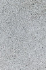 Gray textured cement wall background with fine concrete chips. Construction backgrounds