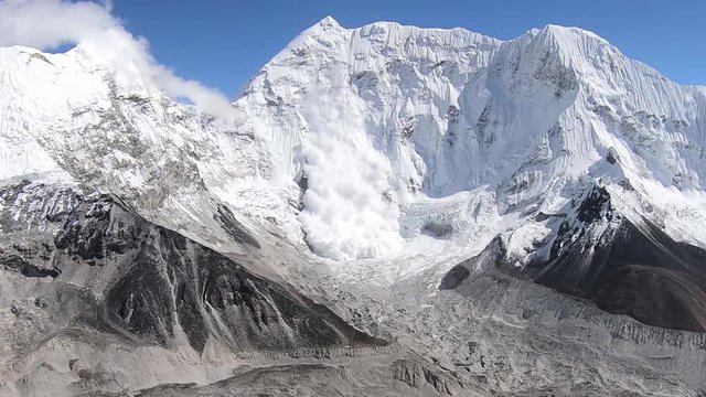 Big snow avalanche sliding down. Mass of snow, ice, and rocks falling rapidly down a mountainside near Island Peak in the Himalayas mountains, Nepal