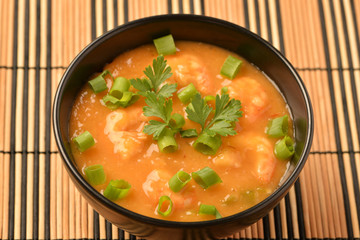 shrimp moqueca with chives, parsley and pepper