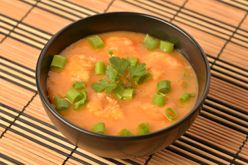 shrimp moqueca with chives, parsley and pepper