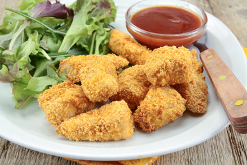plate of chicken nuggets with ketchup