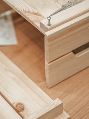 Construction, assembling furniture, screw in a nail with a screwdriver, carving