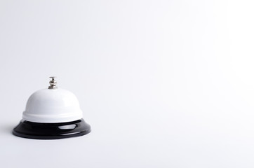 Brigth call bell on the white surface.Empty space for text