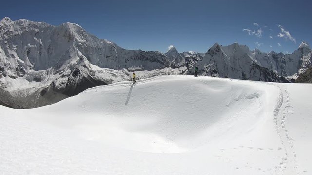Climbers summit Island Peak of the Himalayas, beautiful sunny day, track in the snow of glacier, in Himalaya, Nepal
