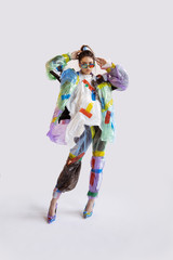 Woman wearing plastic on white background. Female model in clothes and shoes made of garbage. Fashion, style, recycling, eco and environmental concept. Too much pollution, we're eating and taking it.